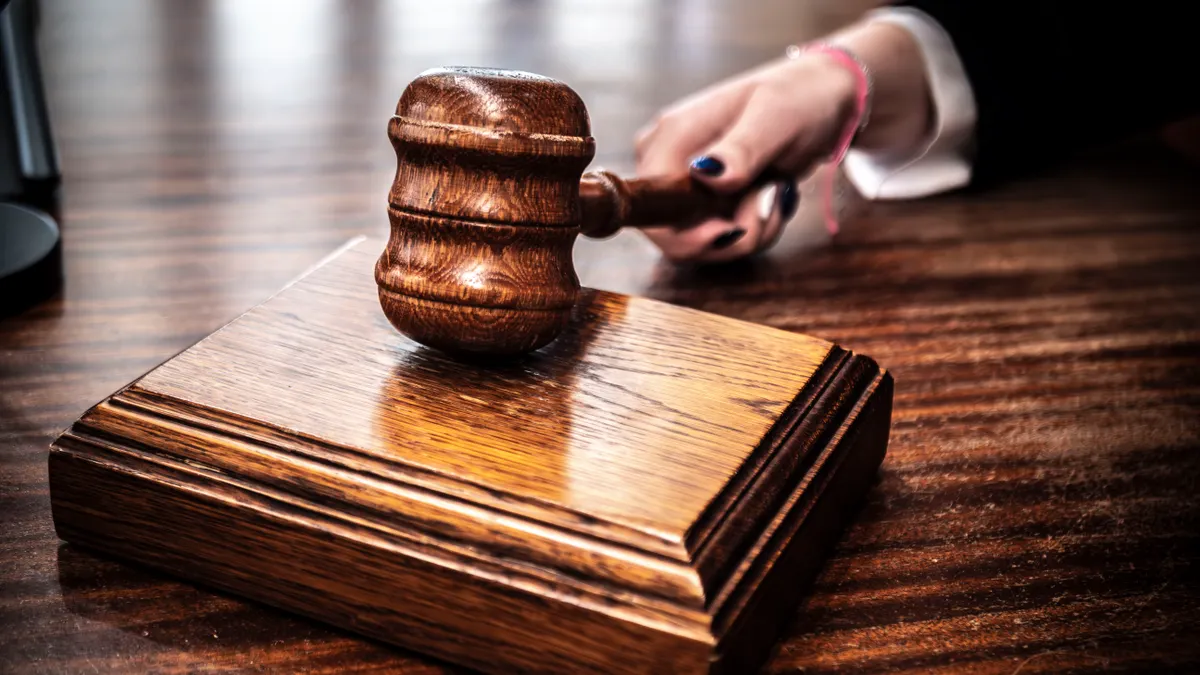 How U.S. Tech Antitrust Cases Affect Big Tech Companies Judge's gavel on a wooden block with a hand nearby