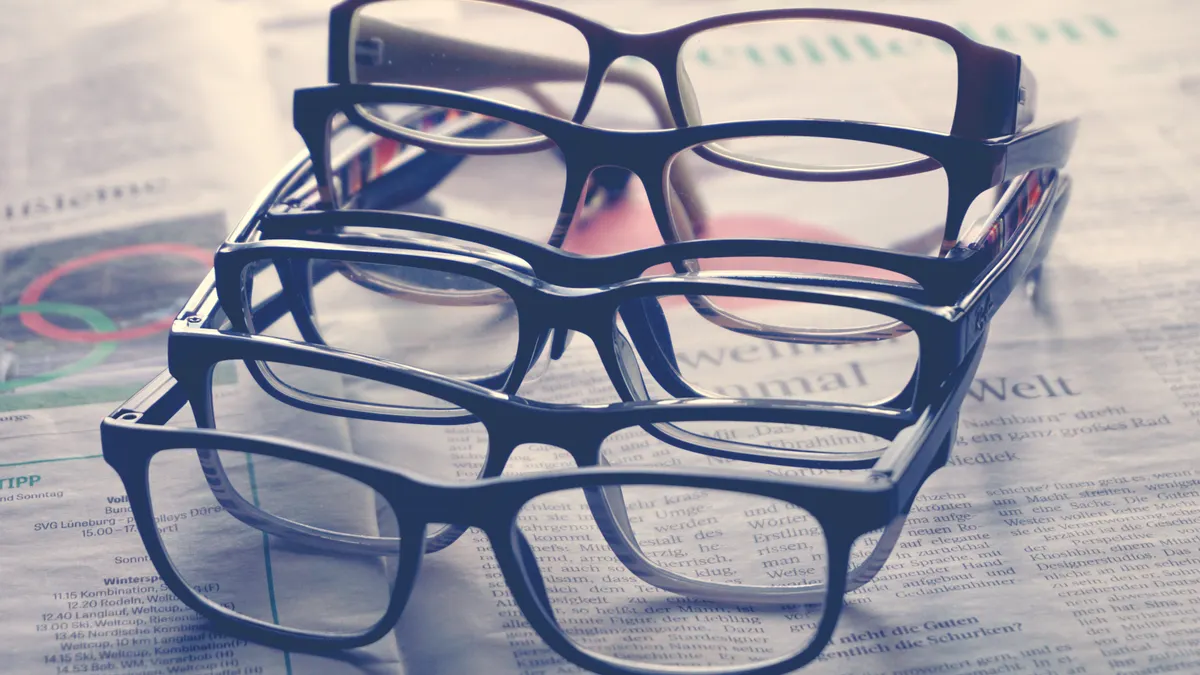Stack of eyeglasses on a newspaper
